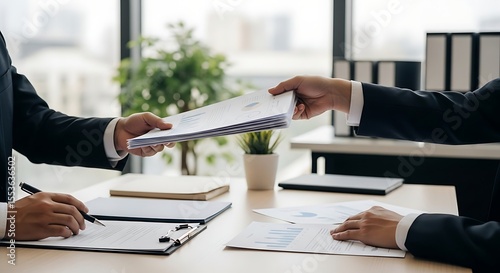 Businesspeople exchange documents