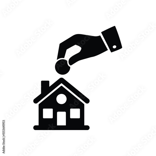 Hand dropping coin into house icon representing saving money for home ownership