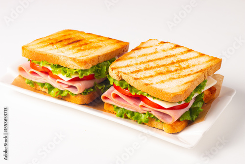 Club sandwich with ham, cheese, tomato and lettuce