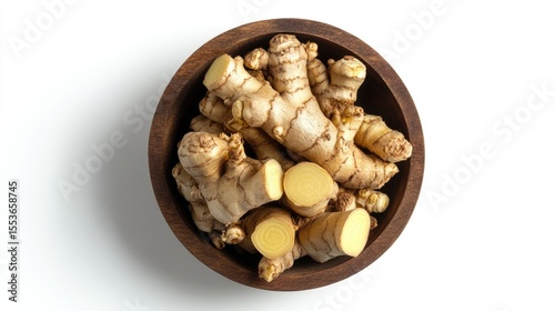 Fresh galangal root in wooden bowl isolated on white background with full depth of field. Top view. Flat lay