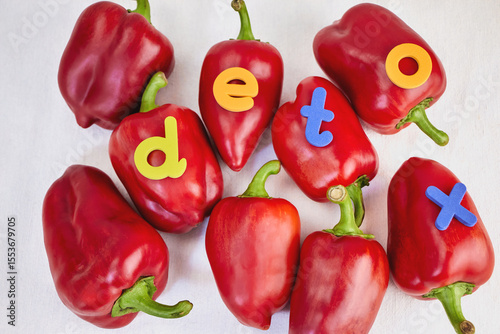 red sweet bell peppers lie on a light background with the inscription detox, the concept of natural and healthy cleansing of the body, close-up