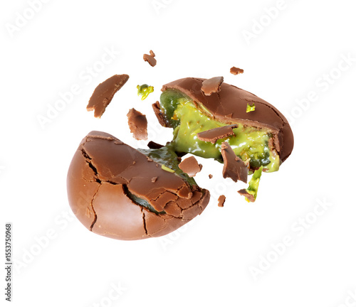Broken chocolate candy with green creamy filling isolated on white background. Dubai chocolate is made with pistachio paste and kadayif