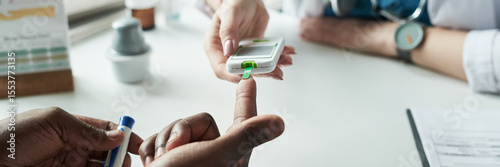 Canvastavla Black adult having blood glucose level checked by medical professional using glu