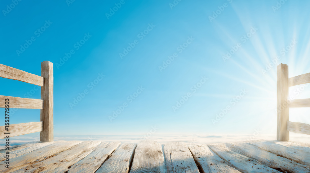 Obraz premium A wooden pier stretches out into a vast, calm expanse under a clear blue sky. The sun rises gently, casting warm rays that illuminate the scene, creating a peaceful atmosphere
