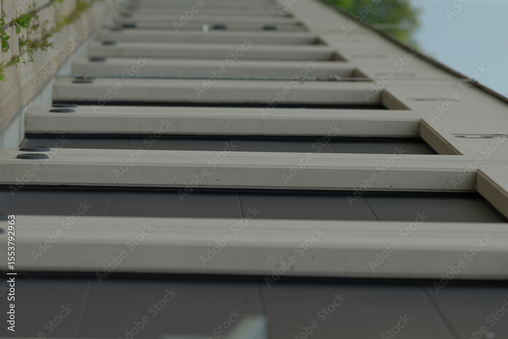 Fototapeta premium There is a row of stairs located on the side of a tall building, creating an architectural feature that enhances accessibility