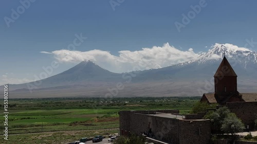 A drone footage of the historic Khor Virap monastery located in the Ararat Plain in Armenia on a sunny day, with Mount Ararat in the background