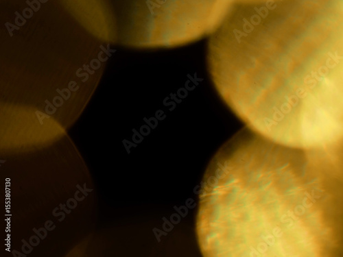 Abstract bokeh scene. Golden light leaks on black color background for design. Light effect.