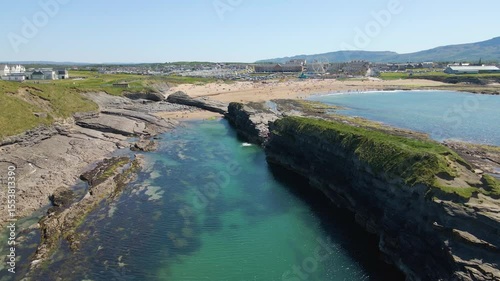Wide drone shot of the cliffs, rocks and beach on a summer day. Bundoran, Donegal, Ireland