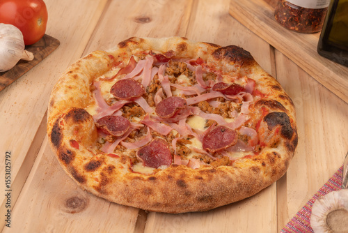 pizza with salami, italian sausage, ham and cheese