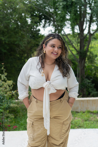 Fashion model posing outdoors, embracing body positivity and plus-size confidence