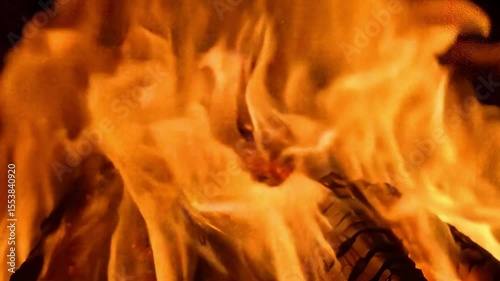A closeup view of intense flames engulfing wood creating a vibrant display of orange and yellow hues