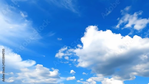 A sunny cloudfilled sky of vibrant blue with scattered puffy white clouds of varying sizes