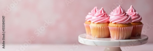Delicate pastel pink cupcakes on a marble pedestal, elegant, baking