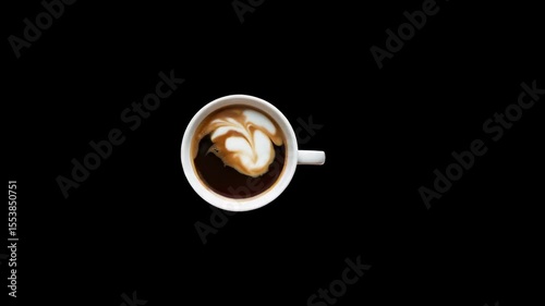 Overhead shot of latte with foam art on black background