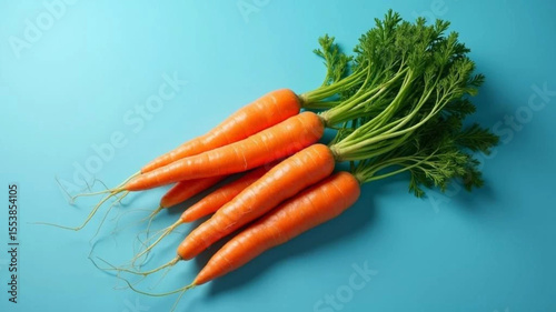 Fresh carrots on blue background. 