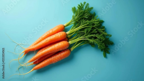Fresh carrots on blue background. 