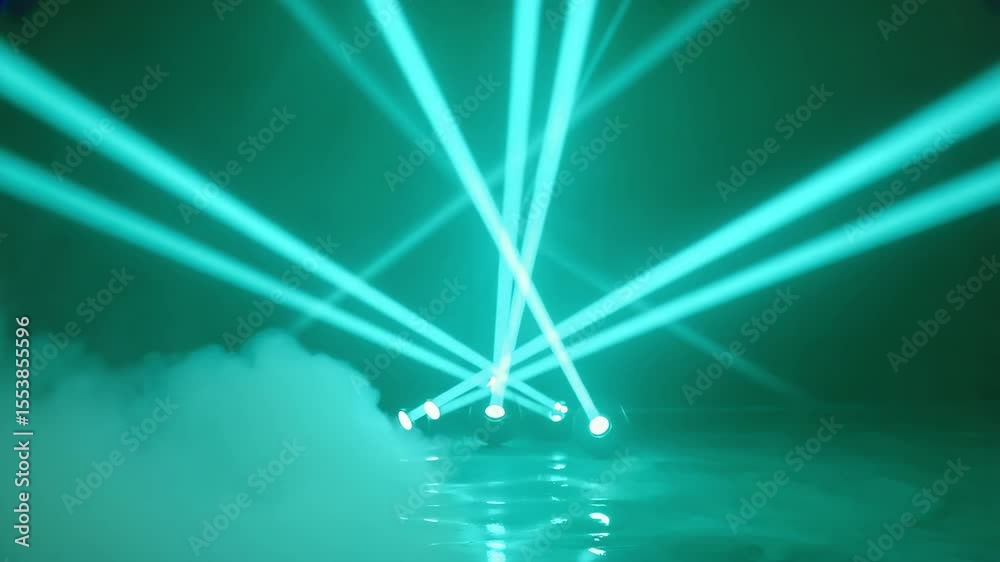 Teal stage lighting with beams and fog creating an atmospheric and dynamic visual effect scene