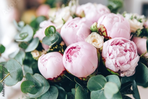 A beautiful peony flower, specifically pink peonies, is shown in close-up, making it suitable for a catalog or online store, and representing the concept of a floral shop, where one can order a