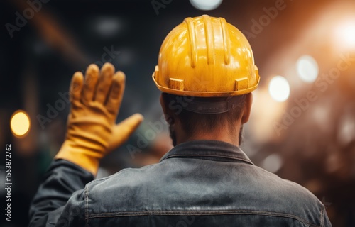 Ironworker signaling crane operator in dynamic industrial environment