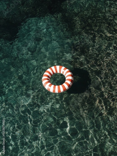Floating Lifebuoy in Clear Turquoise Water on Sunny Day.
