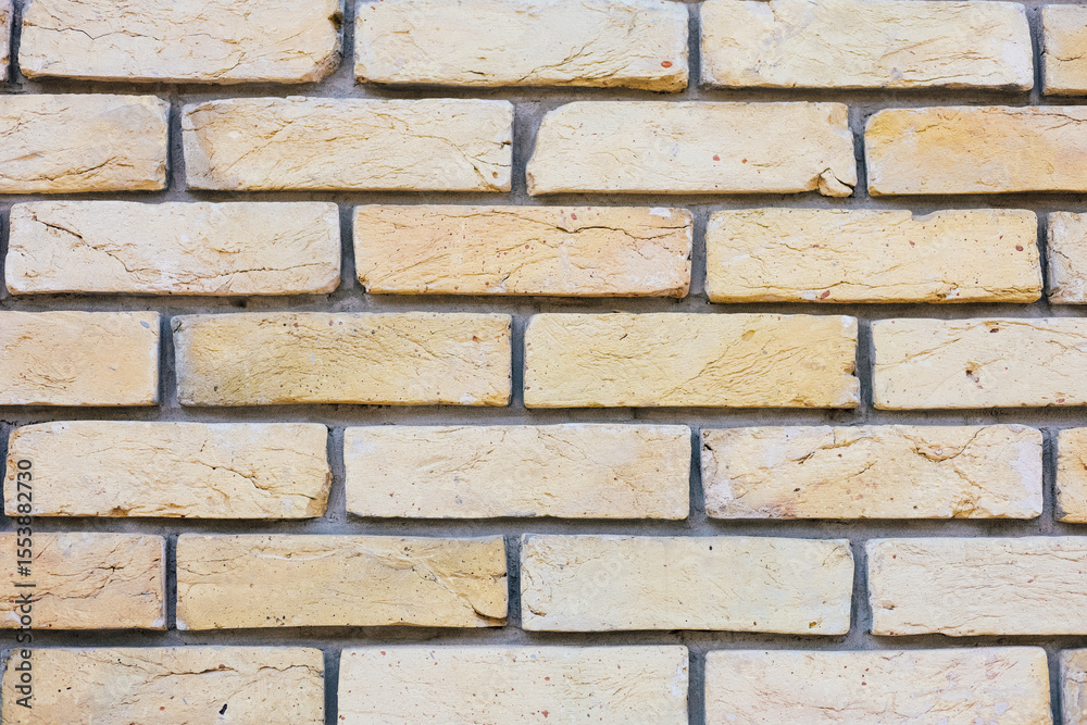 Naklejka premium Textured yellow brick wall enhances urban architecture and design appeal in interior spaces