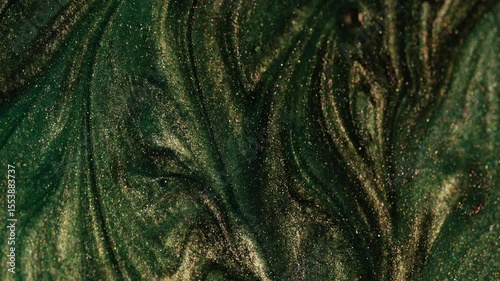 Abstract background with green and gold glitter. Iridescent texture. Universal background