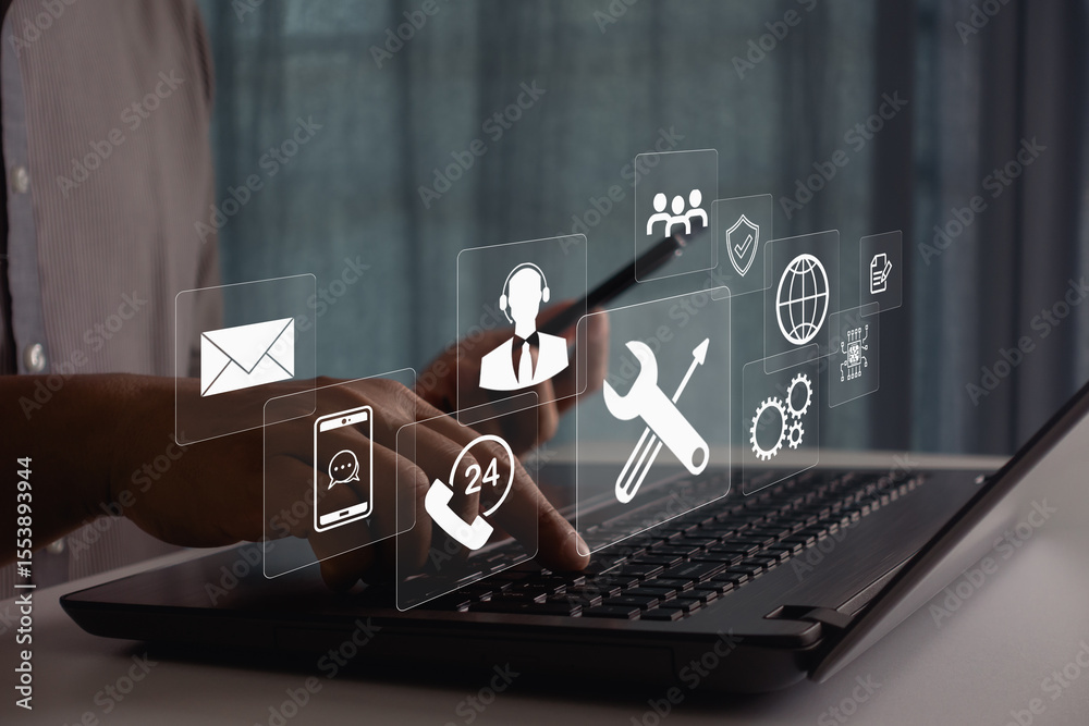 Fototapeta premium Businessman using laptop and smartphone for 24/7 customer support, technical assistance, and online service with digital communication icons, global technology. Concept for consulting and remote help.