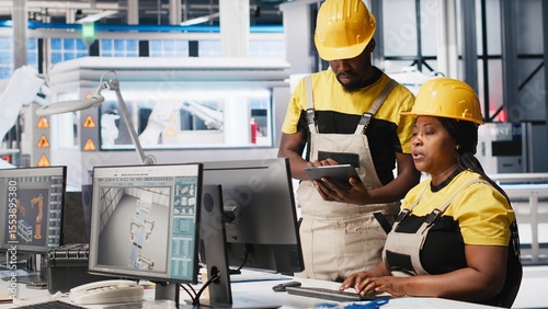 Slika na platnu African american team of employees doing quality control on pc, troubleshooting and fixing technical issues for solar panel production at the factory