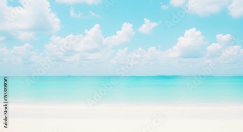A serene beach scene with white sand, turquoise water, and cloudy sky view