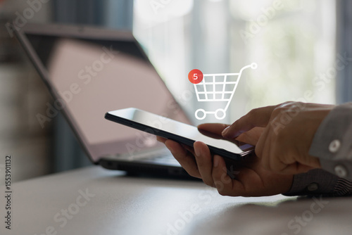 Person using smartphone and mobile phone for online shopping with hand clicking buy button and accessing e-business shopping cart in digital lifestyle modern commerce. Business technology, cyberspace.