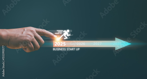 Business start up concept. Businessman pointing at running icon and start arrow for new business on 2025. Achieve business planning and start projects for success. Challenge business strategy.