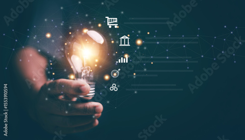 Business global internet connection application technology and digital marketing. Hand holding lightbulb with business icon on network connection. Creativity innovation and new ideas for business.