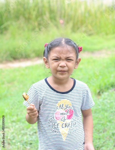 Portrait of asian cute little girl eating food