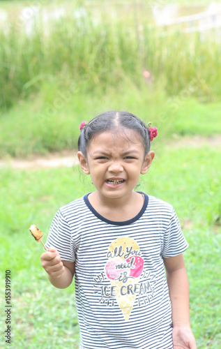 Portrait of asian cute little girl eating food