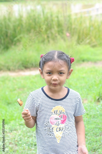 Portrait of asian cute little girl eating food