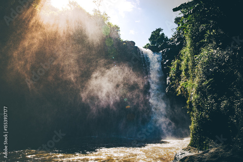 Golden Mist Over Jungle Waterfall at Sunrise