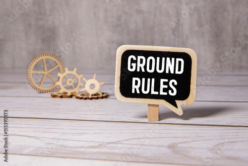 Ground rules words written on wooden blocks with blue background. Conceptual ground rules symbol
