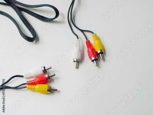 RCA cable with red, yellow, and white connectors, used for audio and video connections, isolated on a white background.
