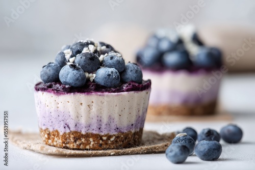 Uncooked vegan vanilla blueberry cheesecake gluten free on a white backdrop Nutritious treat
