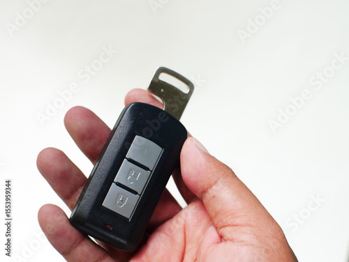 hand holding a Car Key on White Background. 