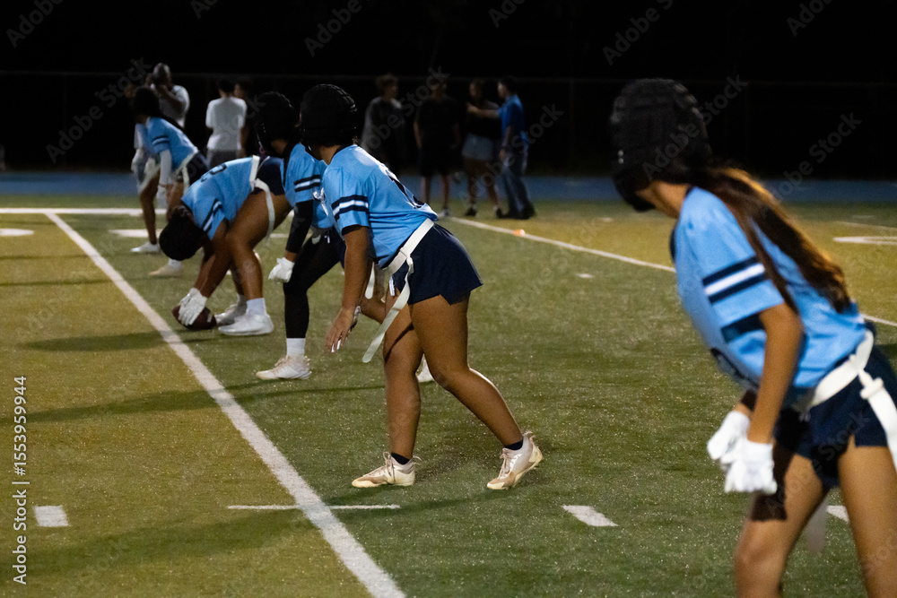 Fototapeta premium Girls flag football team lines up at line of scrimmage 