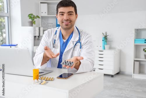 Male doctor with laptop and...