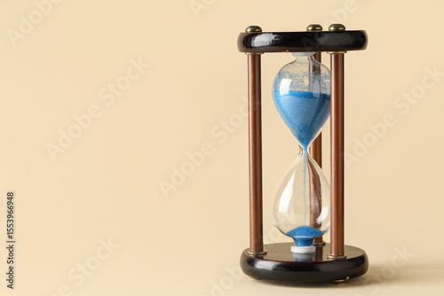 Hourglass on beige backgrou...