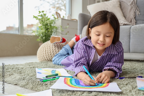 Cute Asian girl drawing on ...