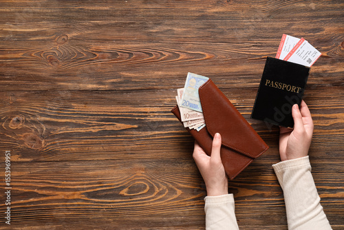 Woman holding wallet with m...
