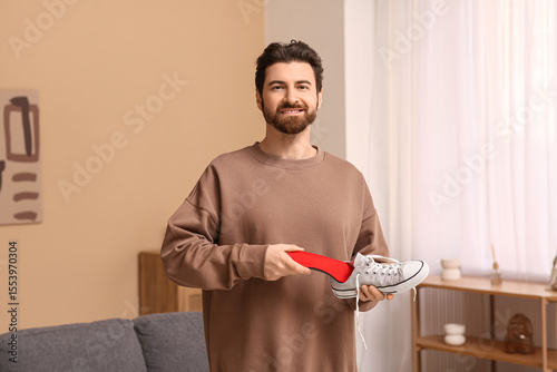Young man putting red ortho...