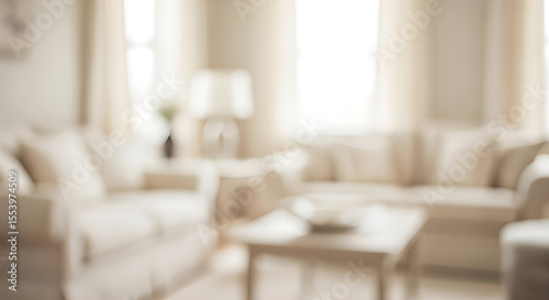 Blurred living room interior with cream sofas and natural light.