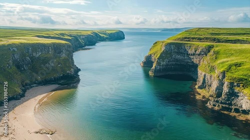 Coastal inlet with sandy beach nestled between verdant cliffs