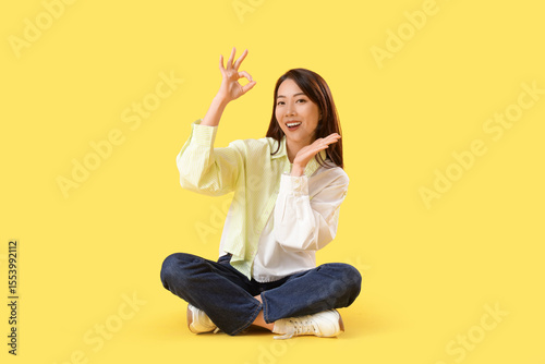 Young Asian woman showing O...