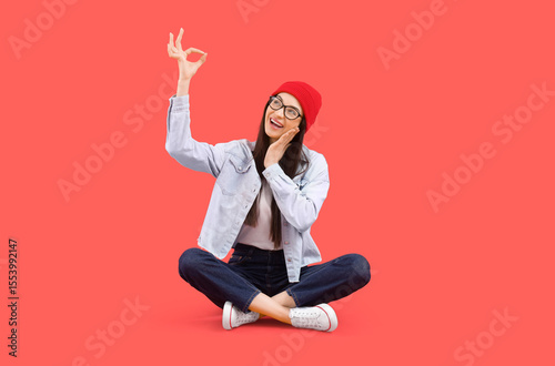Young woman showing OK on r...
